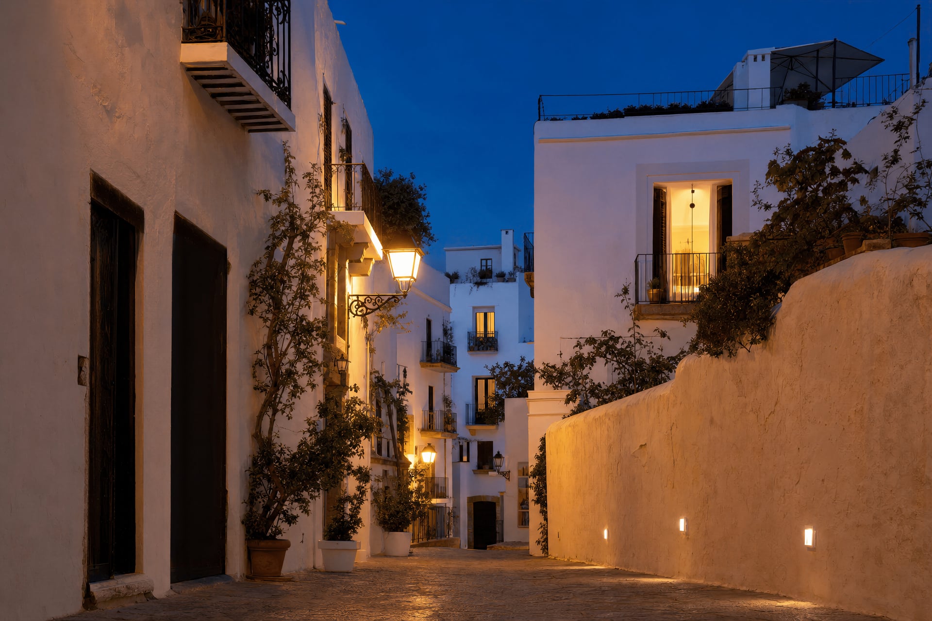 Calm evening street scene in Ibiza Town with warm lamplight and a relaxed neighbourhood mood