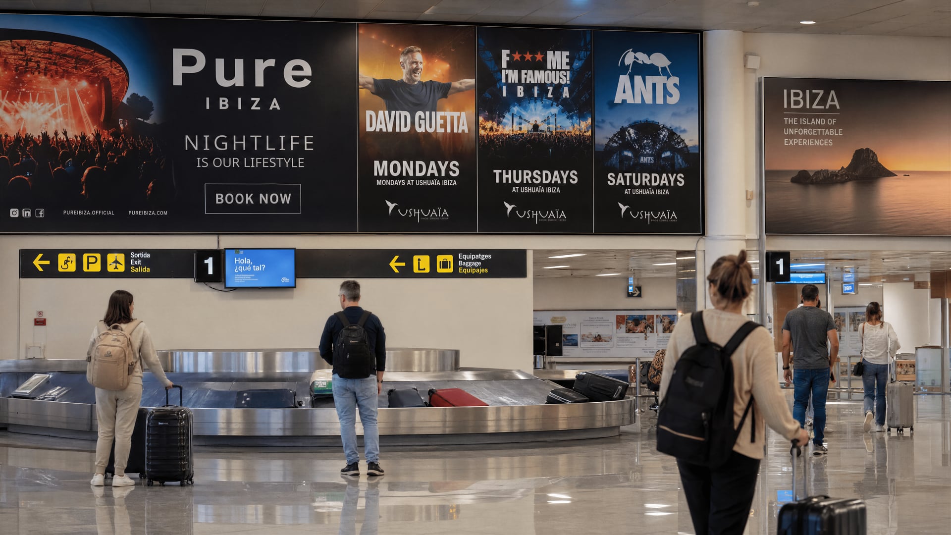 Passengers collect baggage beneath nightclub advertising in Ibiza Airport arrivals