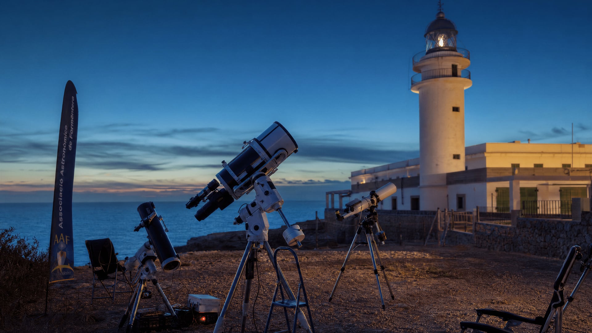 Telescopes positioned near a Formentera lighthouse for eclipse observation