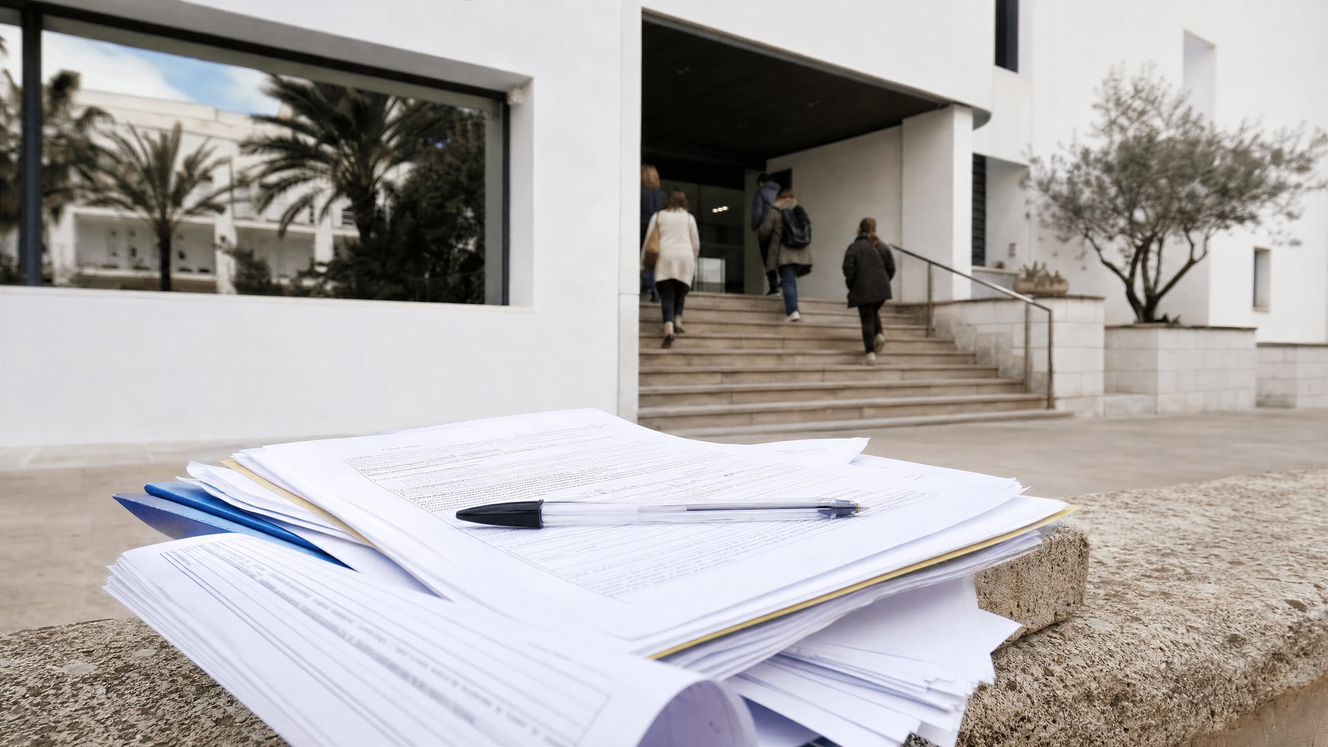 Exterior of the Consell de Ibiza building with grant application forms on a desk
